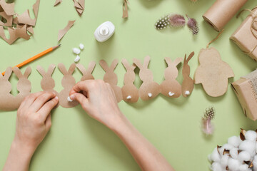 DIY. Easter garland made of kraft paper with rabbits.