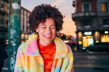 Portrait young black woman laughing posing outdoor having fun positive attitude city night