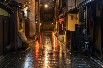 Empty alley in Kyoto's historic Gion district at night after rain