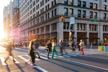 Colorful crowds of people walking through the busy intersection on 23rd Street and 5th Avenue in New York City