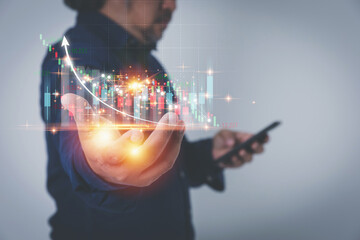 Stock market investment, Business growth, and stock trading concept. Businessman, The trader is showing a chart of growing virtual hologram stock planning and strategy with copy space.