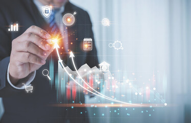 Businessman using a pen touching growth chart and graph virtual screens it is a symbol of business investment growth. Business finance, accounting, and investments concept.
