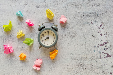 New idea concept with crumpled colorful sticky notes  and alarm clock 