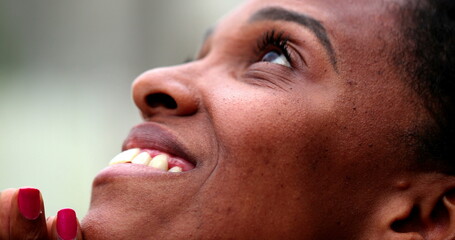 African female opening eyes to sky in peace © Marco