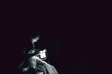 Obraz na płótnie Canvas sad child ghost at night,Halloween Festival concept,Friday 13th,Horror movie scene,A girl with doll