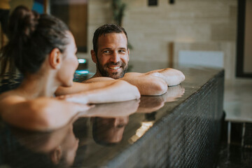Young couple relaxing in a swimming pool