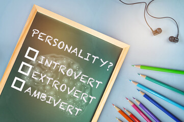 Personality introvert, extrovert and ambivert with brain on chalkboard on white background. Human personality type concept and shy or outgoing person idea - obrazy, fototapety, plakaty