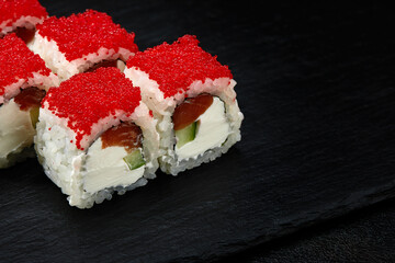 Sushi. Philadelphia roll with fresh salmon, cucumber, avocado, cream cheese, tobiko red caviar