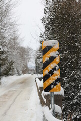 snow covered road sign