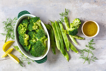 Set of raw ingredients for preparing a healthy vegetarian dinner. Baked broccoli with green beans...