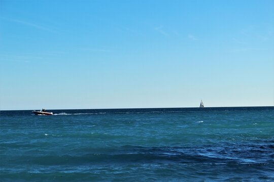 A motor boat and sailboat out at sea in the Mediterranean (Cagnes-sur-Mer, France)