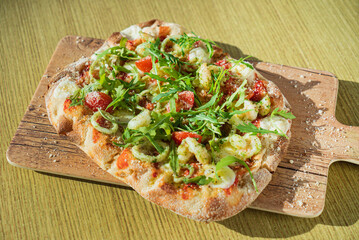 fresh pizza with calamari and arugula