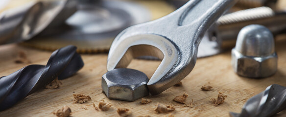 bolt screw by hex wrench in wooden oaks plate with with drill bit and circular saw