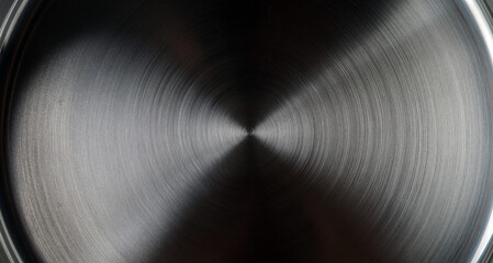 Surface texture of stainless steel pan with concentric circles. View from above.