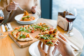 woman eating pizza in the cafe