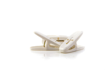 white plastic clothespins on white background