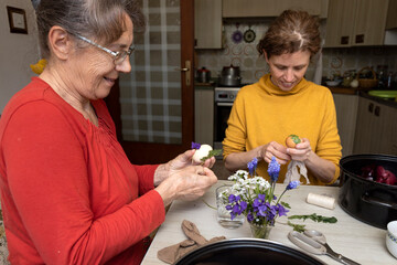 Obraz na płótnie Canvas Mother and Daughter Creating Easter Decorations in Domestic Serenity