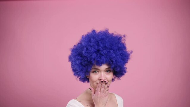 Close-up Portrait of Young Smiling Woman In blue Wig. Millennial woman blows kiss.
