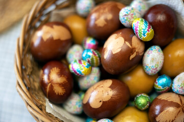 Fototapeta na wymiar Easter Table Decoration With Traditional Easter Eggs and Chocolate Eggs