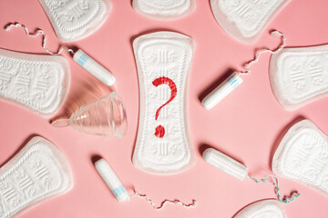 Pad, menstrual cup, tampon on a pink background. The view is flat. Concept of critical days,...