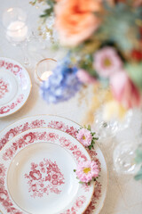 wedding place setting with pink and white china