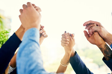 All we need is each others support. Closeup shot of a group of unrecognizable businesspeople holding their hands in solidarity.