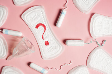 Close up pad, menstrual cup, tampon on a pink background. The view is flat. Concept of critical days, menstruation - obrazy, fototapety, plakaty