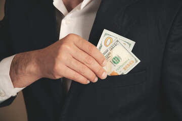man hand money on suit pocket on grey background