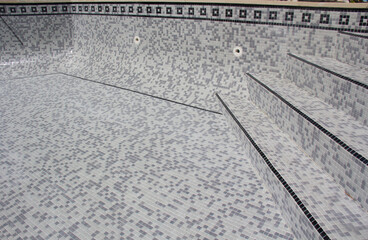 Fototapeta premium Tiles being applied to refurbish a swimming pool. now requires grouting. Series of images taken during a Swimming pool refurbishment