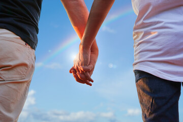 gay couple hands holding each other background blue sky, concept LGBTQ life