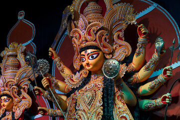 Decoated Goddess Durga idol , Durga Puja festival at night. Shot under colored light at Howrah, West Bengal, India. Biggest festival of Hinduism , celebrated all over the world.