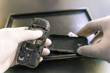 Man's hand in rubber protective , staff change SIM card, selling travel sim in a shop for customers to buy, 4K measures to prevent infection from coronavirus - 19.