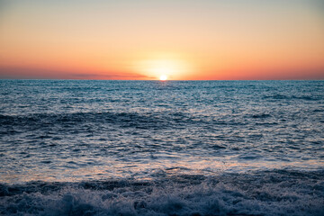 The sea wave. Sunset in the sea. The power of the elements. Landscape photography.