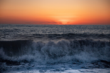 The sea wave. Sunset in the sea. The power of the elements. Landscape photography.