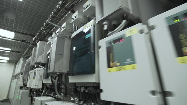 Data center server room, Switchgear room with raws of cabinets with network or cellular hardware. Electrical energy distribution substation in a new factory plant, Industrial electrical switch panel