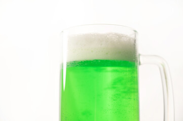 A pint of green beer for st patrick's day on a white background. Traditional Irish drink for a holiday