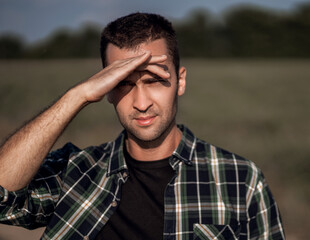 handsome manly man with short bristles in a checkered shirt