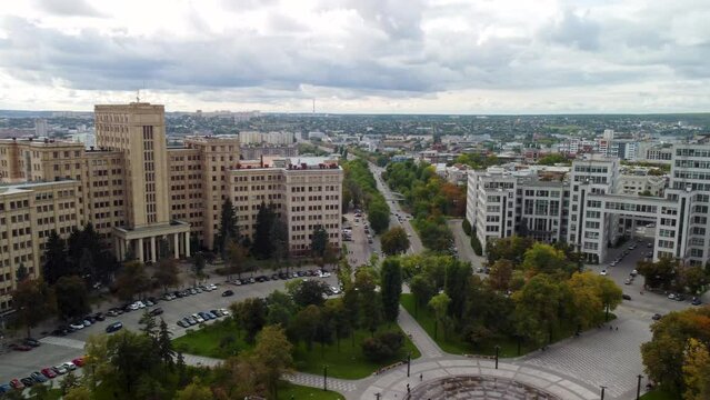 Autumn city center aerial left to right panorama view from Freedom Svobody Square on Derzhprom historic constructivist architecture building with epic clouds in Kharkiv, Ukraine
