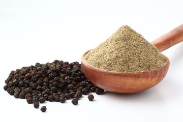 Indian spices Black Pepper powder in a wooden spoon with pepper corns on white background