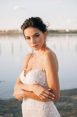 Close-up portrait of a brunette model girl in the role of a bride. Beautiful face, portrait at...