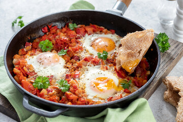 Shakshouka, eggs poached in sauce of tomatoes, peppers and onion. Keto meal, low carb.