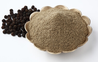 Indian spices Pepper Powder in brass bowl with pepper corn