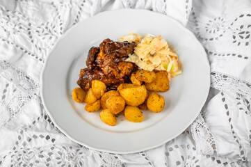 Baked sliced turkey meat in wild gypsy sauce, fried potato and salad coleslaw.