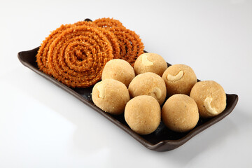 diwali snacks or diwali food or diwali sweets ,diwali snacks chakali or chakli, laddu, flowers and diya