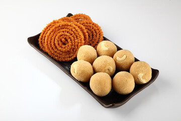 diwali snacks or diwali food or diwali sweets ,diwali snacks chakali or chakli, laddu, flowers and diya