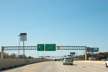 Fototapeta na wymiar HOUSTON, TEXAS - March, 2022: Traffic signs and signals all over the freeway road