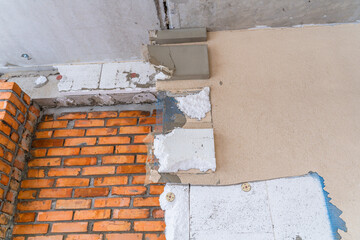 Dismantled polystyrene insulation and facade coating of a private house. Remodeling the exterior of the house