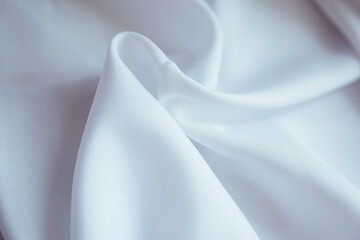 Crumpled white fabric lies in folds and drapery.