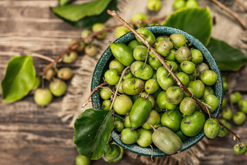Harvest of ripe Actinidia arguta kiwi in a ceramic bowl