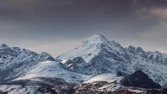 Time lapse of dark clouds over a snow capped Monte San Parteo in the Balagne region of Corsica